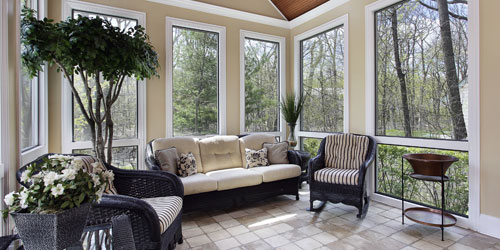 Sunroom filled with floor to ceiling windows and french doors